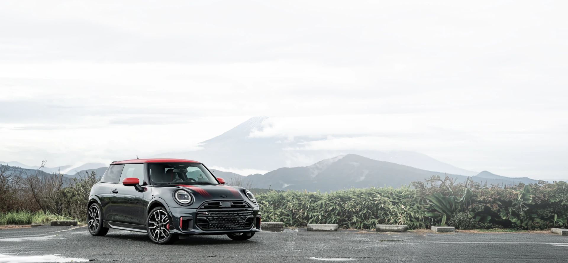 Black and red MINI showing warning icons on the windshield and front grille.